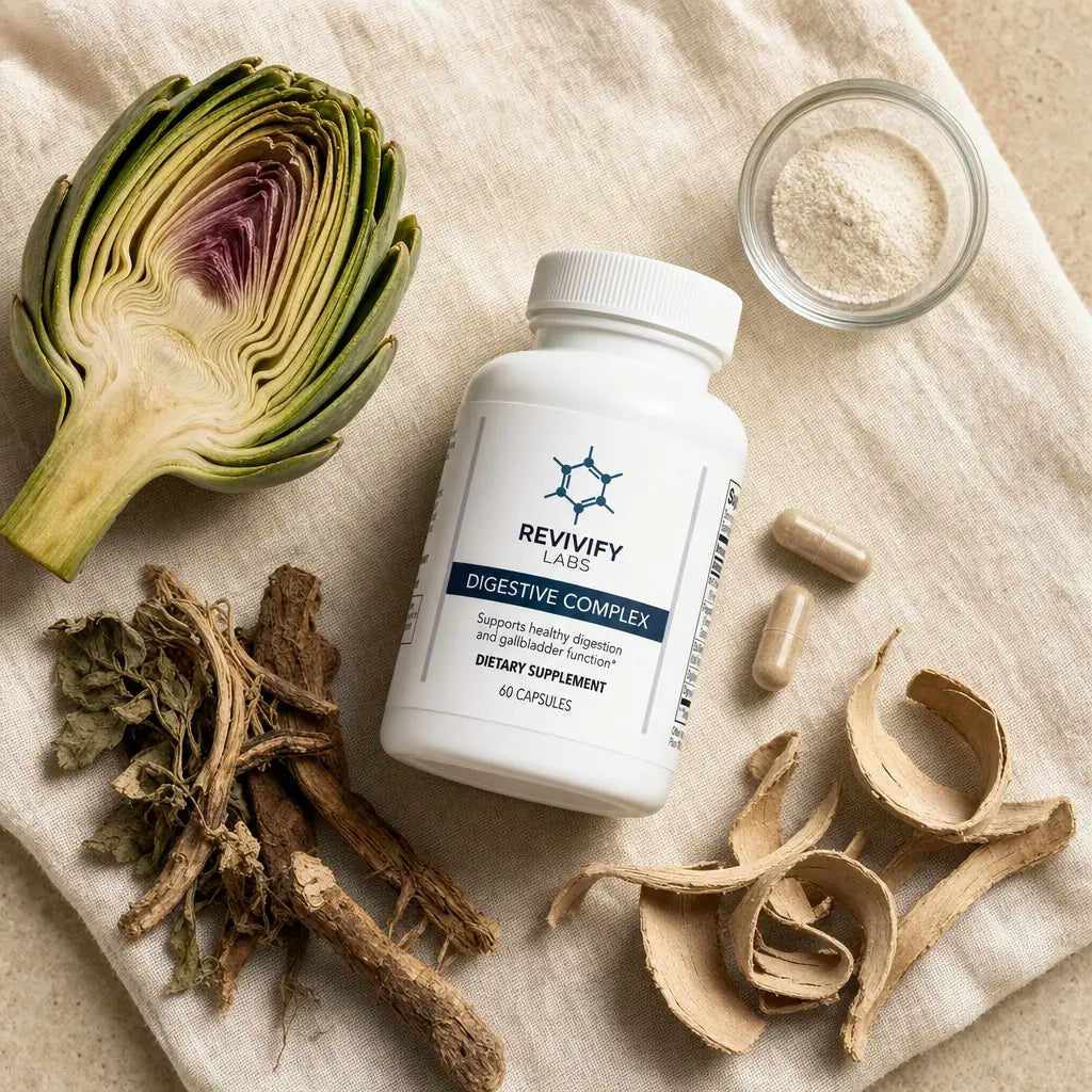 Digestive Complex bottle laid flat surrounded by artichoke, enzyme powder, bitter herbs, capsules and slippery elm bark